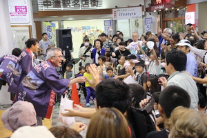 餅まきで賑わう会場の様子