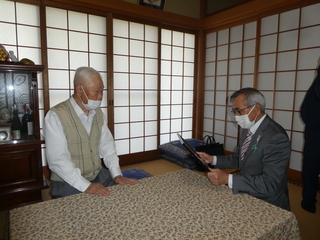 表彰状を手渡す奥塚市長（写真右）