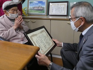 お祝い状を渡す奥塚市長